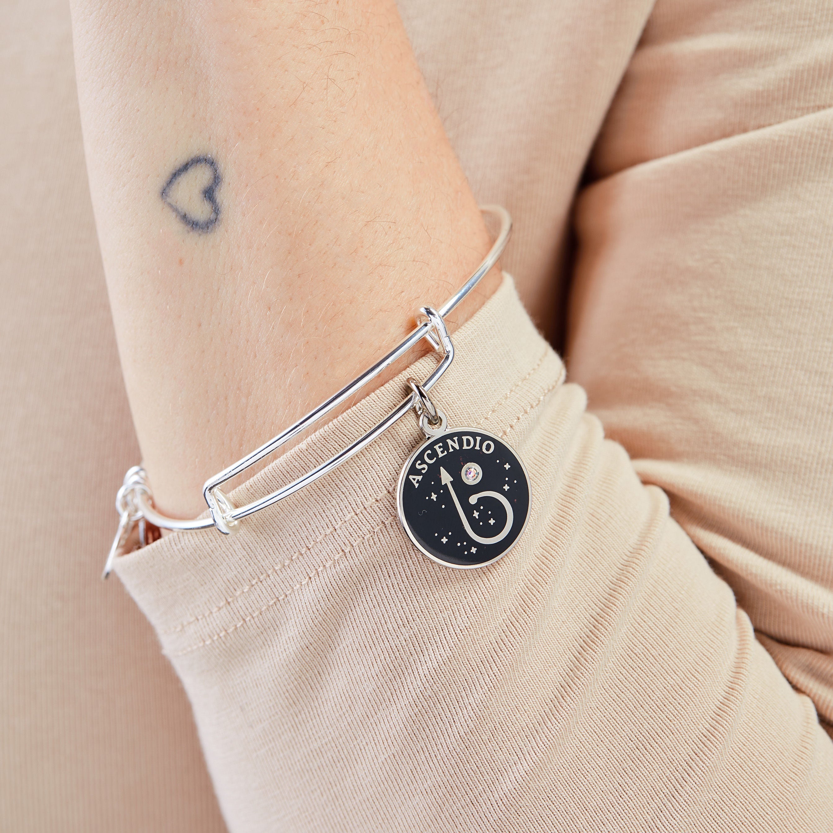 Shiny silver Harry Potter™ Ascendio charm bangle bracelet by ALEX AND ANI, featuring magical design and intricate detailing.