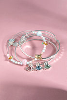 Set of three silver ALEX AND ANI crystal bunny bangle bracelets featuring delicate bunny charm designs.