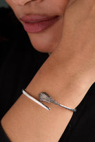 Silver Wizard of Oz Wicked Witch Broom Bypass Cuff bracelet by ALEX AND ANI featuring a detailed broom design.