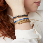 Set of ALEX AND ANI Evil Eye Stranded™ bracelets in stainless steel and gold, featuring protective evil eye charms.