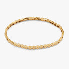 Gold stainless steel tennis bracelet with a Lucky Clover charm by ALEX AND ANI, featuring a elegant and dainty design.