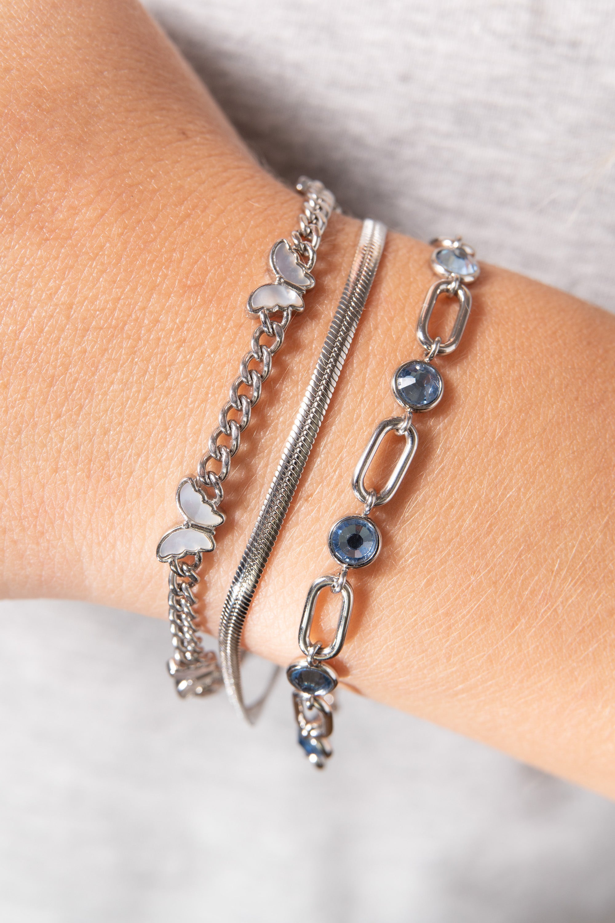 Silver butterfly curb chain bracelet by ALEX AND ANI featuring a stainless steel design and delicate butterfly charm.