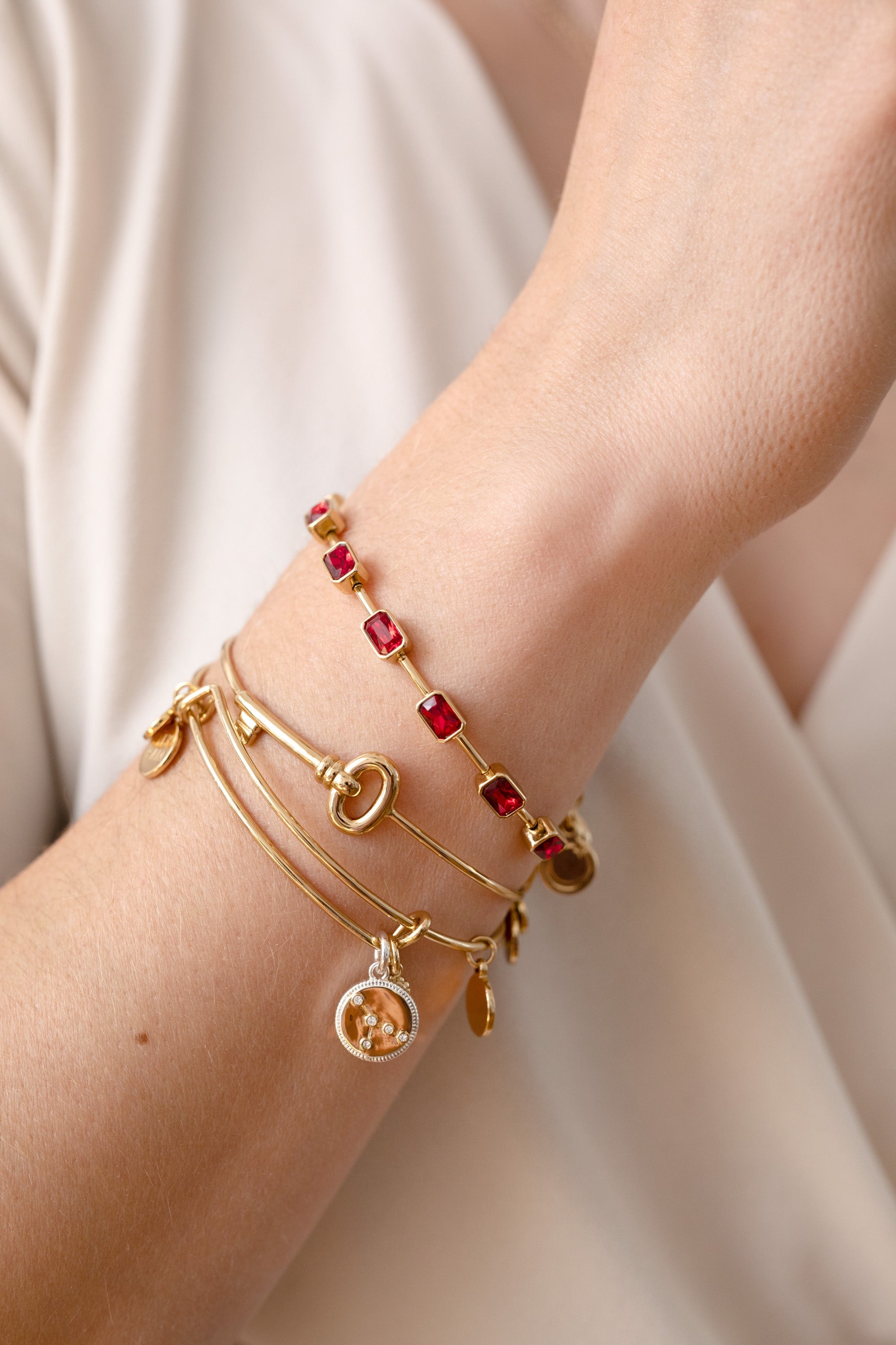 Two-tone Cancer Zodiac charm bangle bracelet by ALEX AND ANI featuring a detailed Cancer symbol charm.