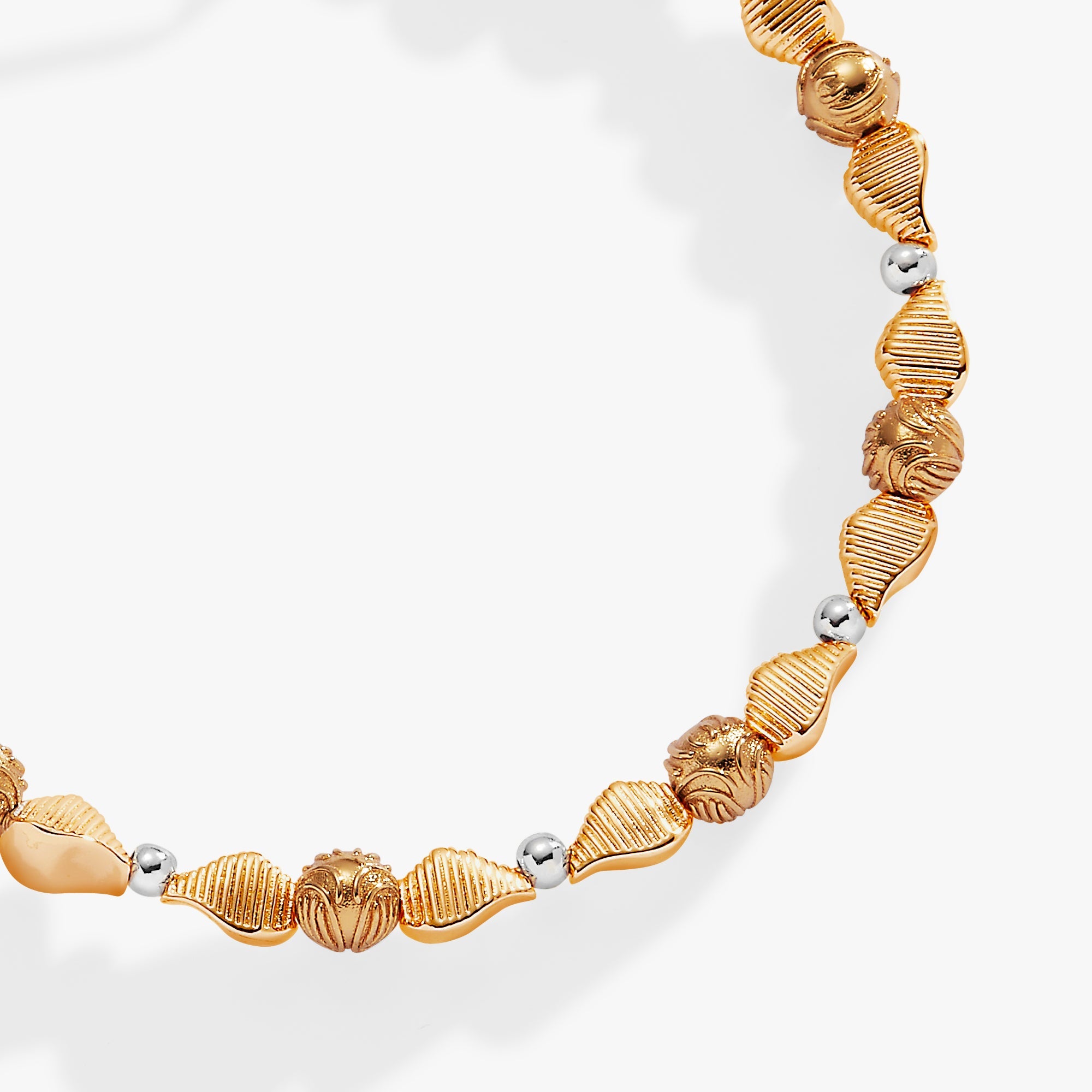 ALEX AND ANI Harry Potter™ Golden Snitch beaded bangle with two-tone metal finish, featuring a detailed Snitch charm.