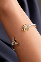 ALEX AND ANI Sunflower and Bee Flex Cuff bracelet in two-tone metal featuring floral and bee motifs.