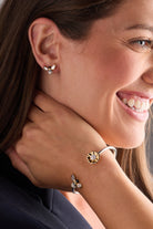 ALEX AND ANI sunflower and bee Flex bracelet with two-tone metal design, featuring detailed sunflower and bee charms.
