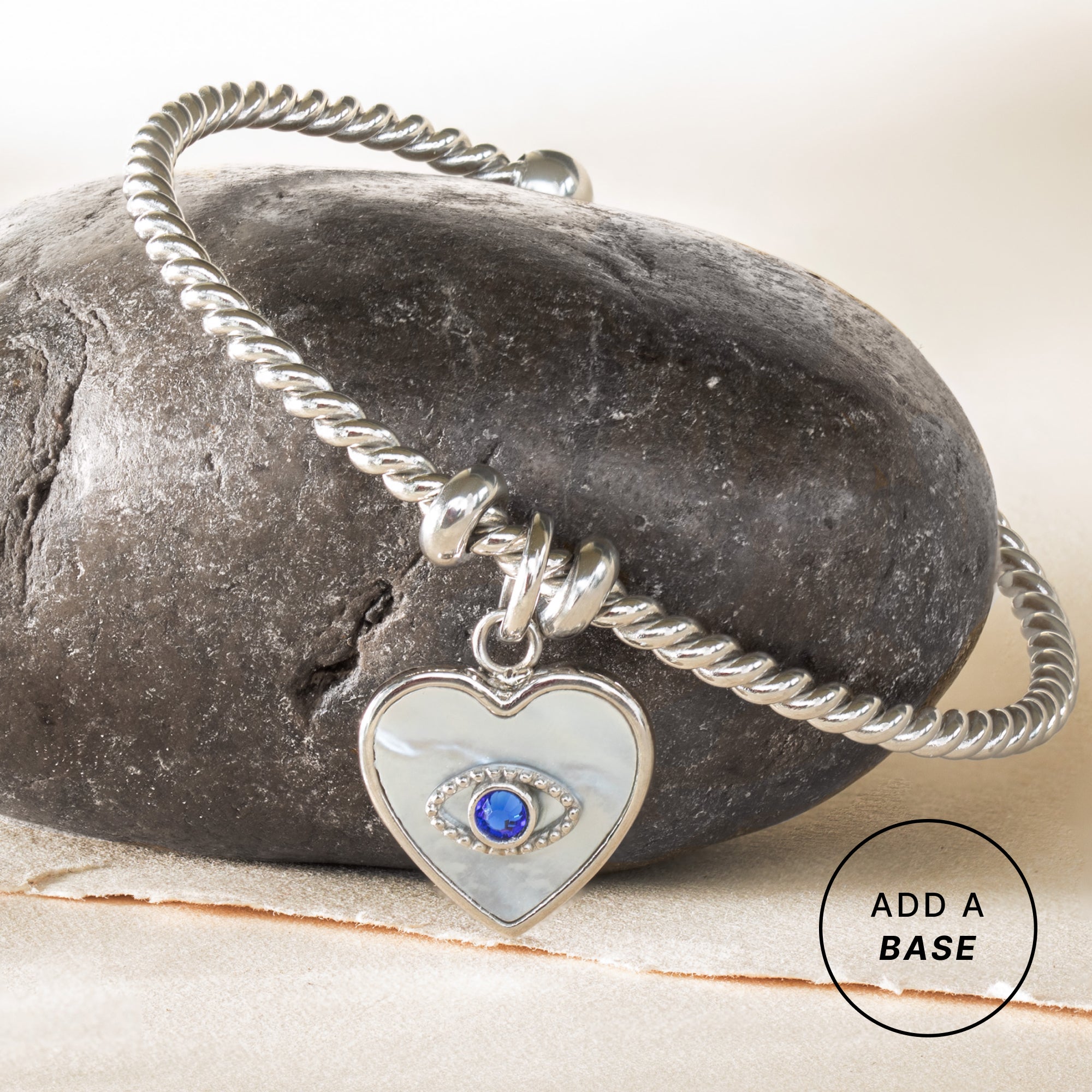 Silver stainless steel Evil Eye Heart charm by ALEX AND ANI, featuring an interchangeable design with detailed eye and heart motifs.