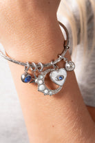 Silver Evil Eye Heart Interchangeable Charm from ALEX AND ANI, featuring a detailed stainless steel heart with an evil eye design.