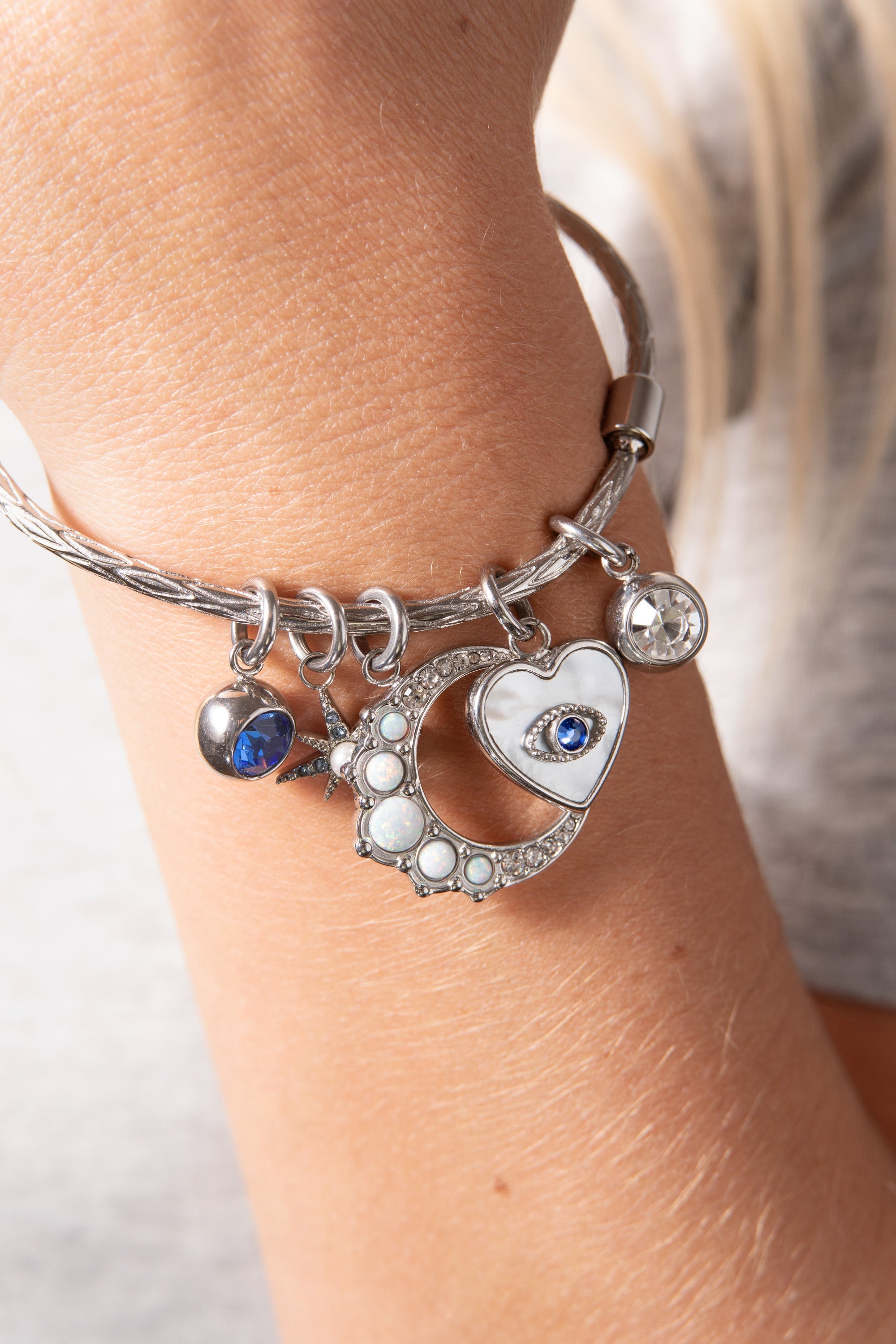 Silver Evil Eye Heart Interchangeable Charm from ALEX AND ANI, featuring a detailed stainless steel heart with an evil eye design.