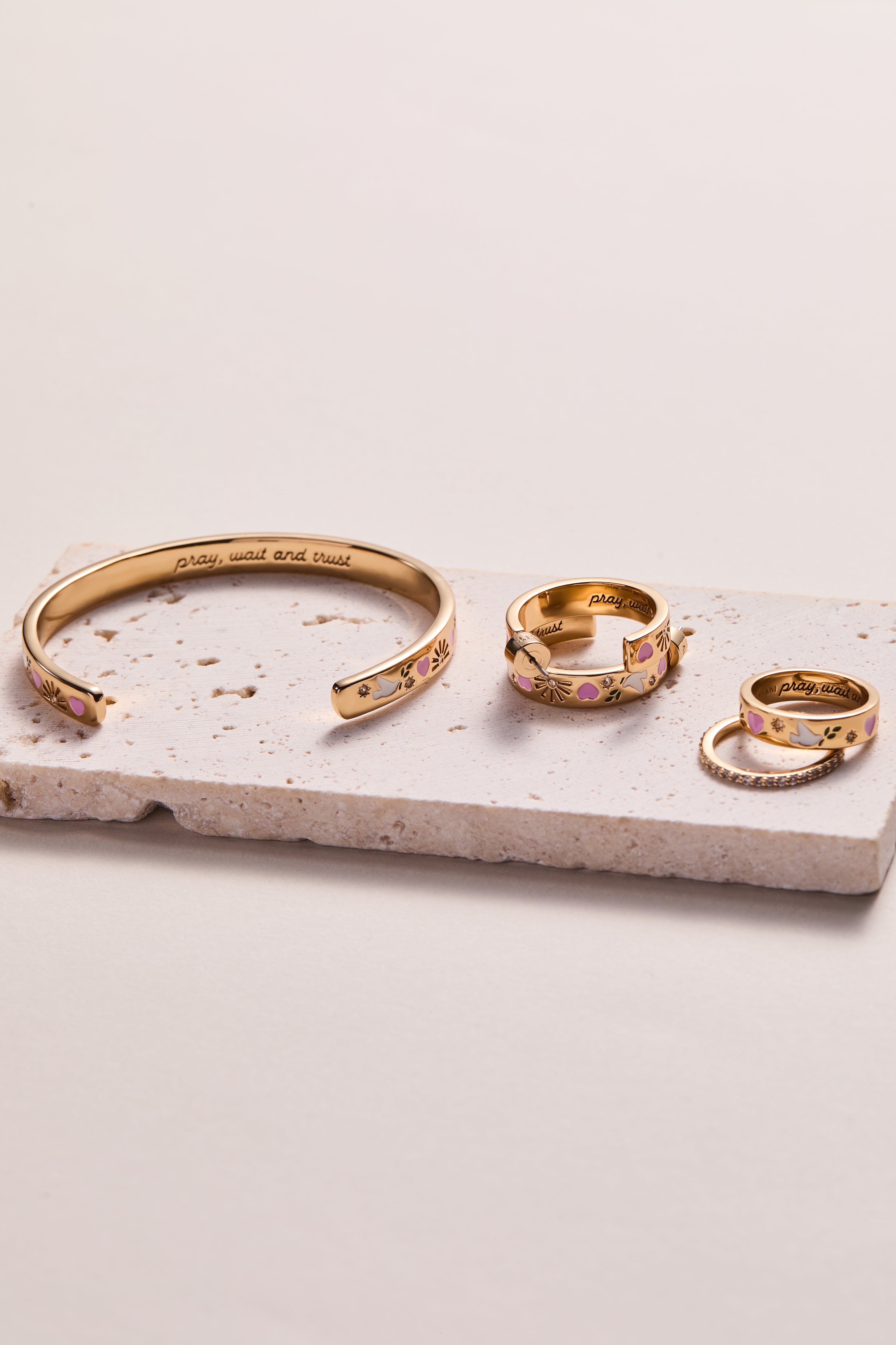 Gold hoop earrings by ALEX AND ANI featuring engraved "Pray, Wait and Trust" design on smooth hoops.