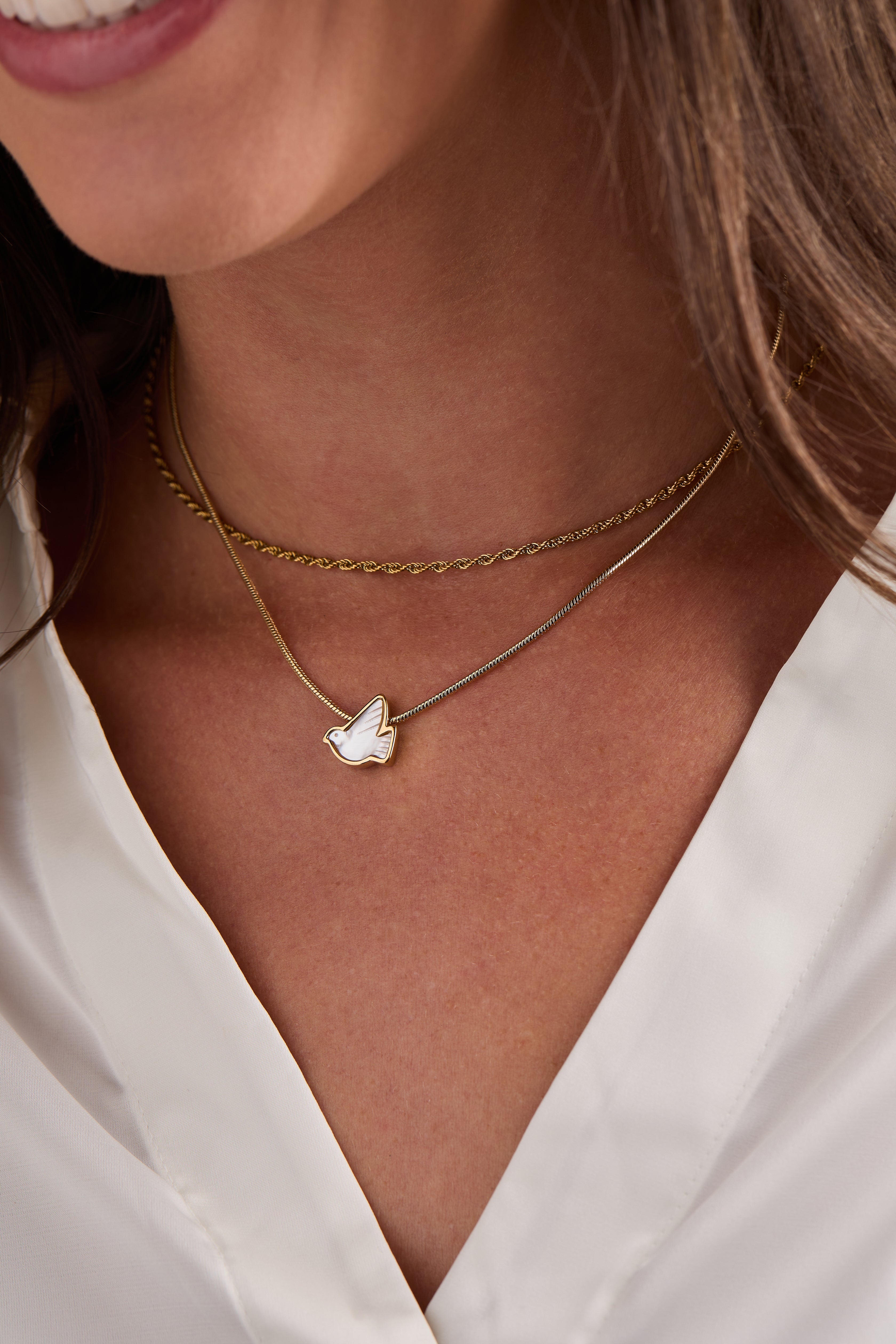 Gold pearlized Dove 'Peace' slider necklace by ALEX AND ANI featuring a dove pendant on a delicate chain.