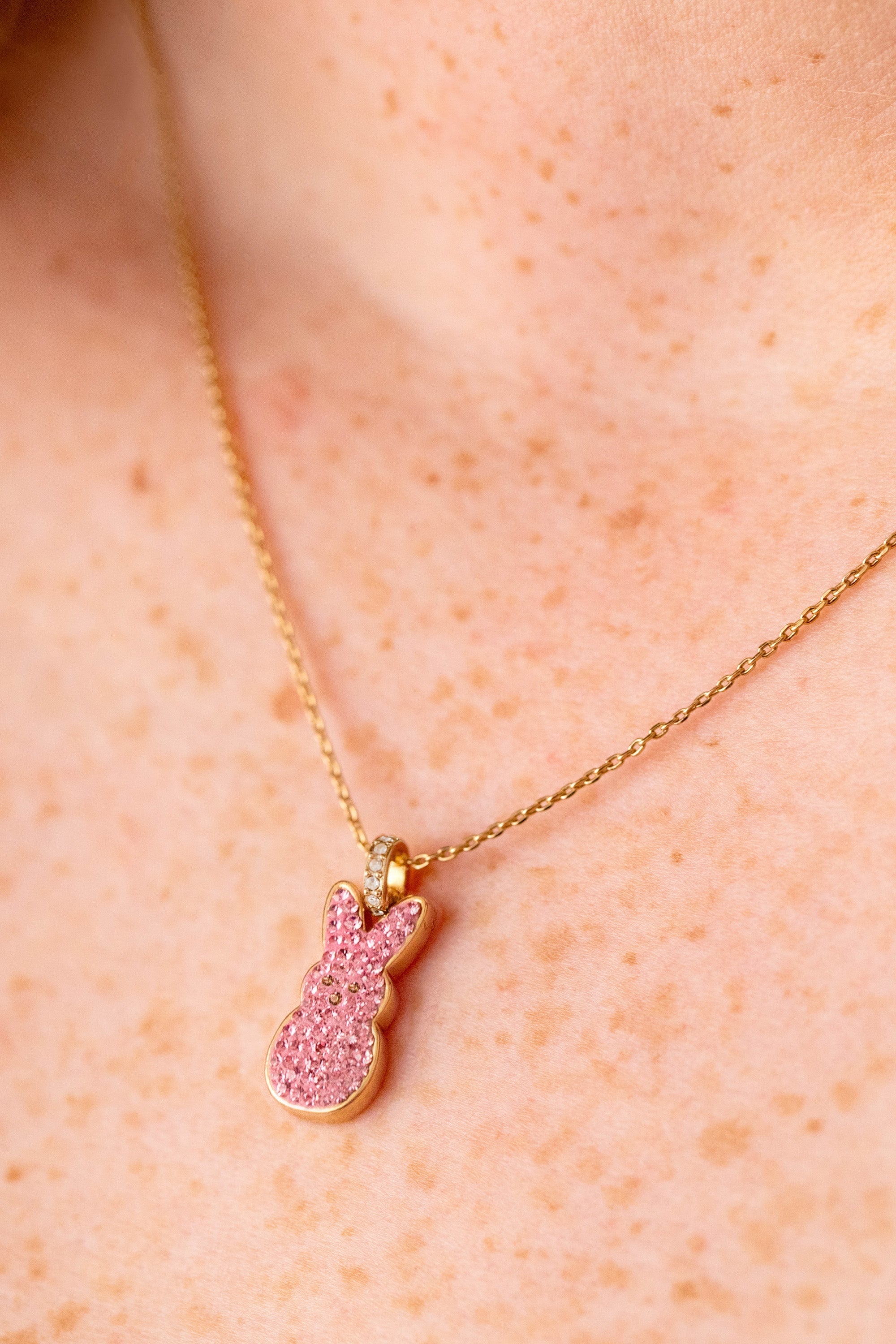 ALEX AND ANI pink crystal bunny pendant necklace featuring a gold chain and a cute bunny charm with sparkling pink crystals.