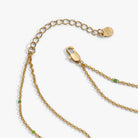 Gold 'Trick or Treat' layered necklace by ALEX AND ANI featuring festive Halloween-themed charms and delicate chain layers.