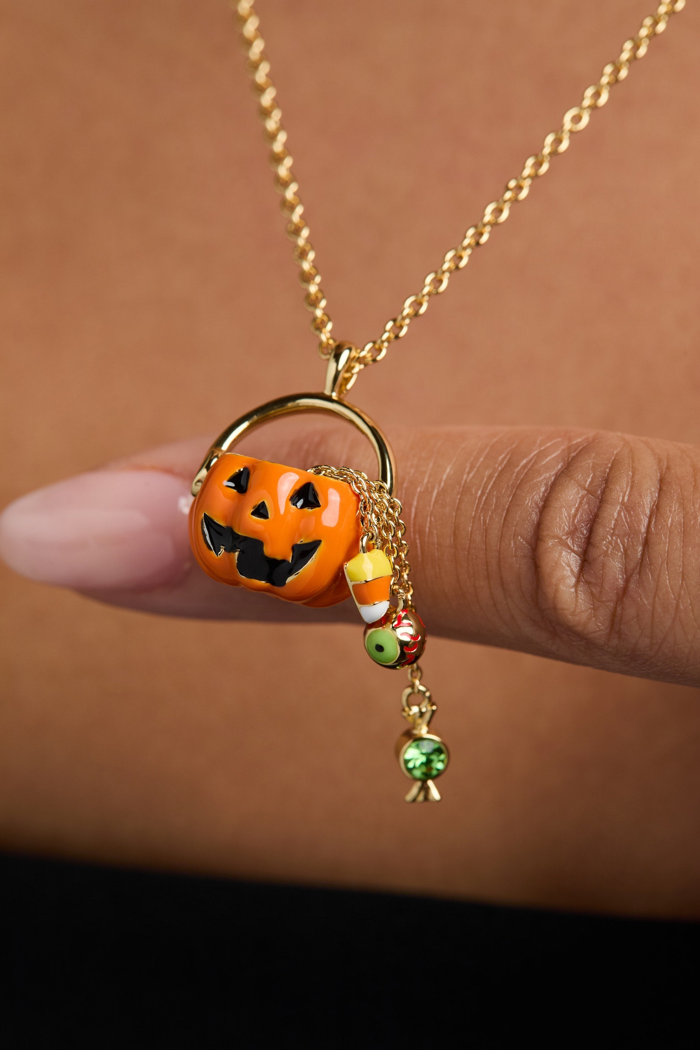 Gold 'Trick or Treat' layered necklace by ALEX AND ANI featuring Halloween-themed charms and intricate design.