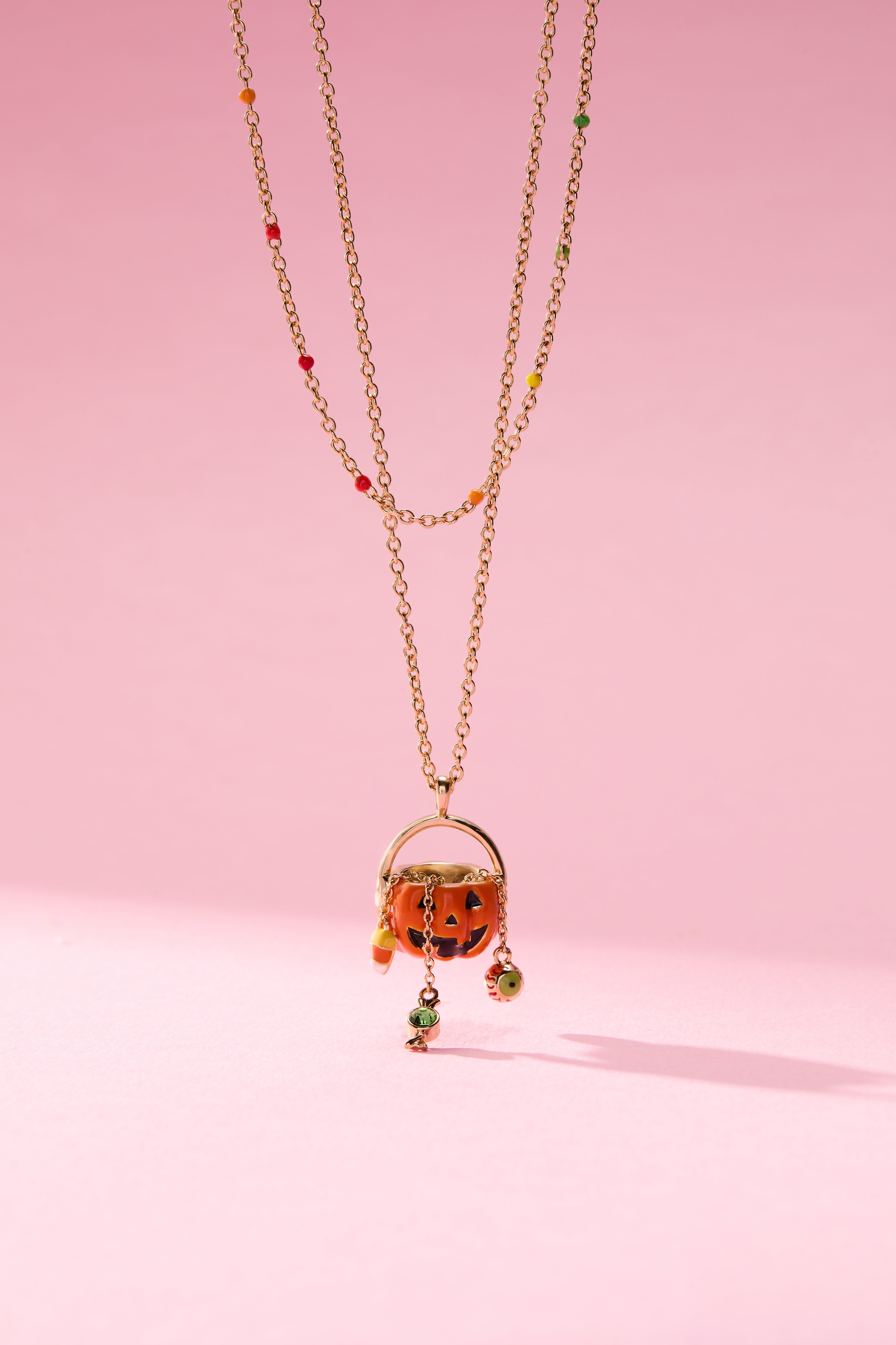 Gold 'Trick or Treat' layered necklace by ALEX AND ANI featuring playful Halloween-themed charms.