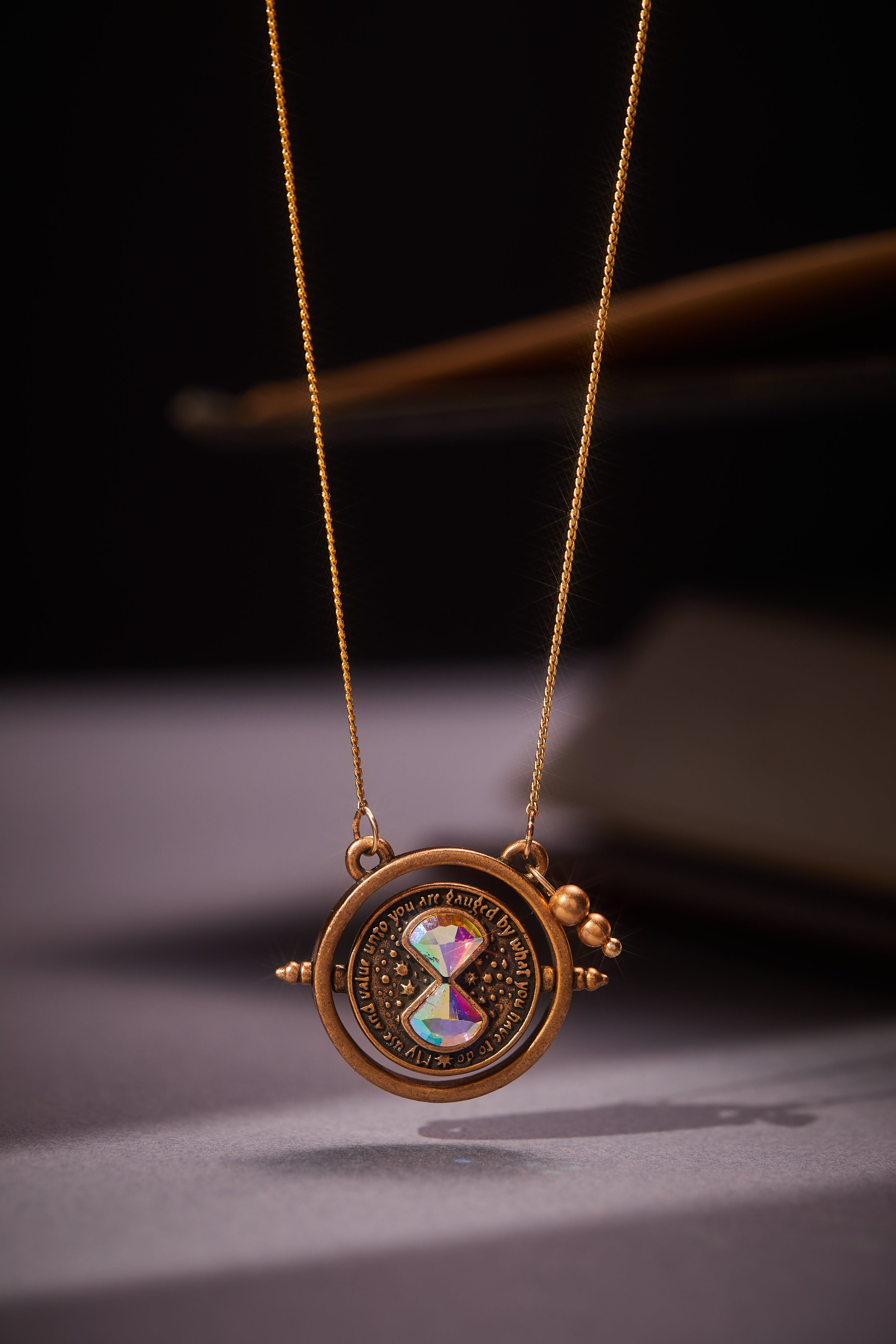 Gold Harry Potter Time Turner Spinner Necklace by ALEX AND ANI featuring a detailed magical pendant on a chain.