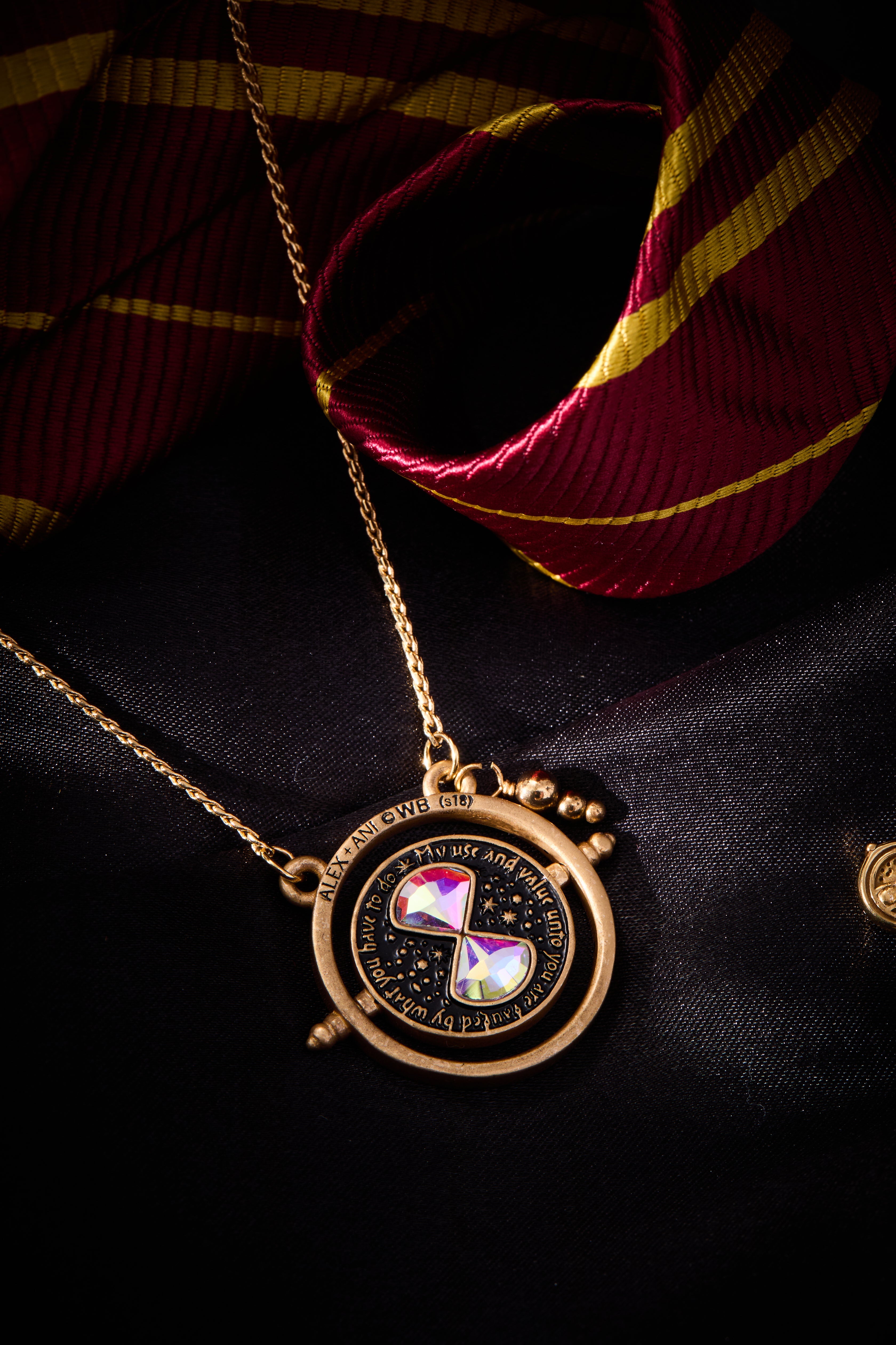 ALEX AND ANI Harry Potter™ Time Turner Spinner Necklace with gold-tone pendant and intricate design, hanging on a chain.