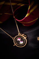 ALEX AND ANI Harry Potter™ Time Turner Spinner Necklace with gold-tone pendant and intricate design, hanging on a chain.