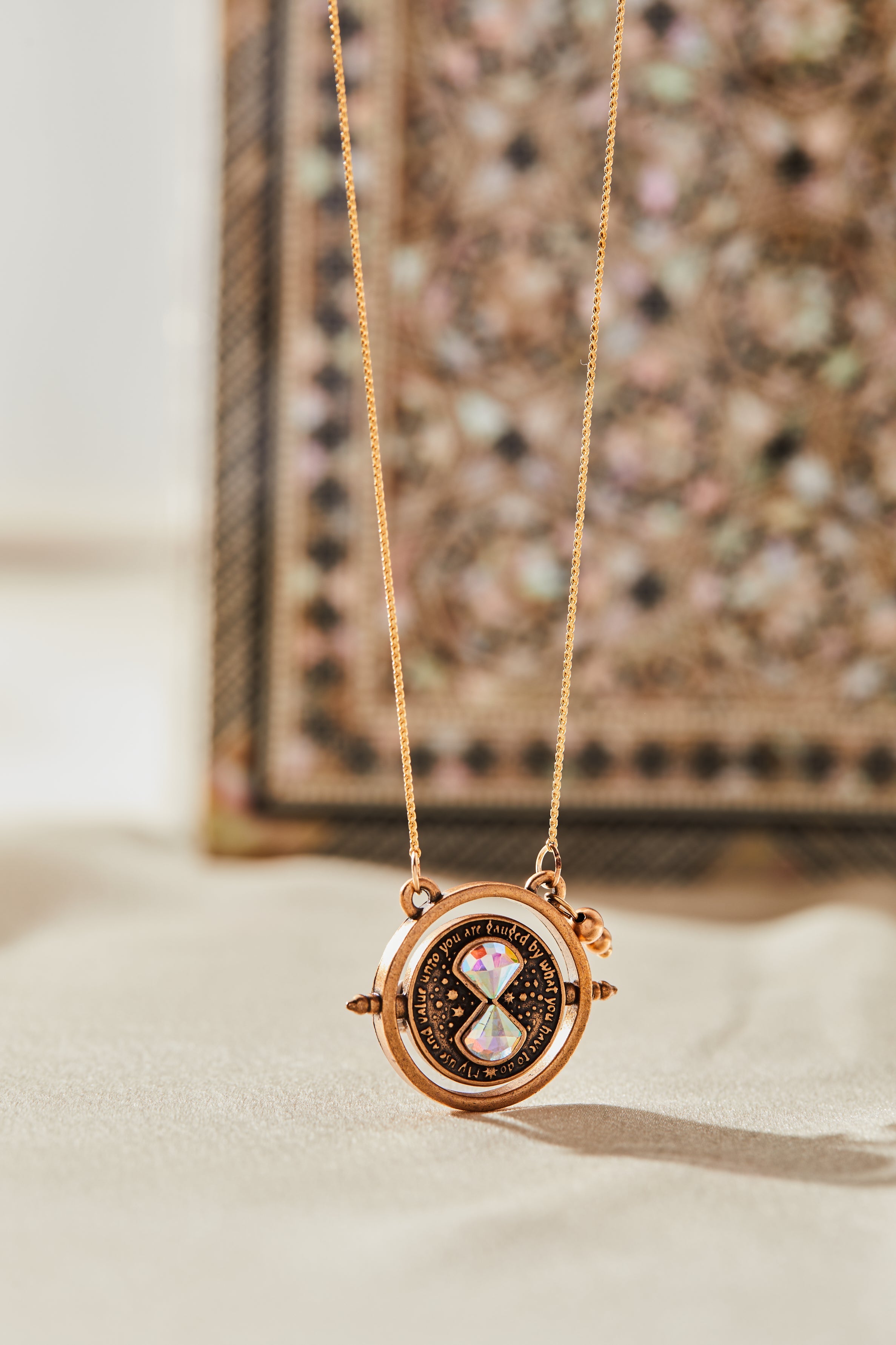 ALEX AND ANI Harry Potter™ Time Turner Spinner Necklace with gold-tone pendant featuring the iconic time turner design.