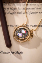 ALEX AND ANI Harry Potter™ Time Turner Spinner Necklace with gold-toned pendant featuring intricate design and spinning time turner charm.