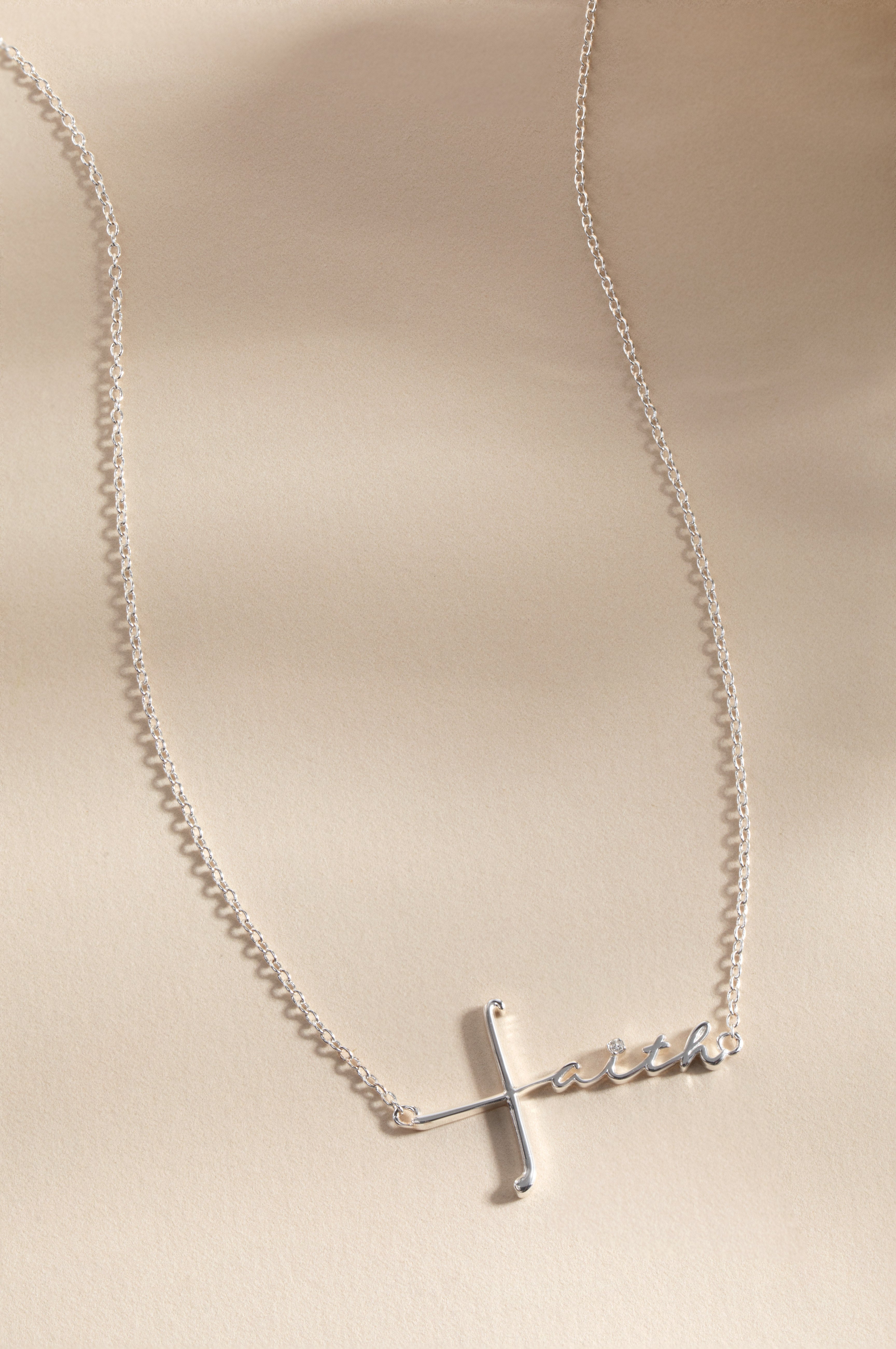 Silver Faith Necklace by ALEX AND ANI featuring a delicate pendant with the word “Faith” on a thin chain.