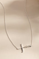 Silver Faith Necklace by ALEX AND ANI featuring a delicate pendant with the word “Faith” on a thin chain.