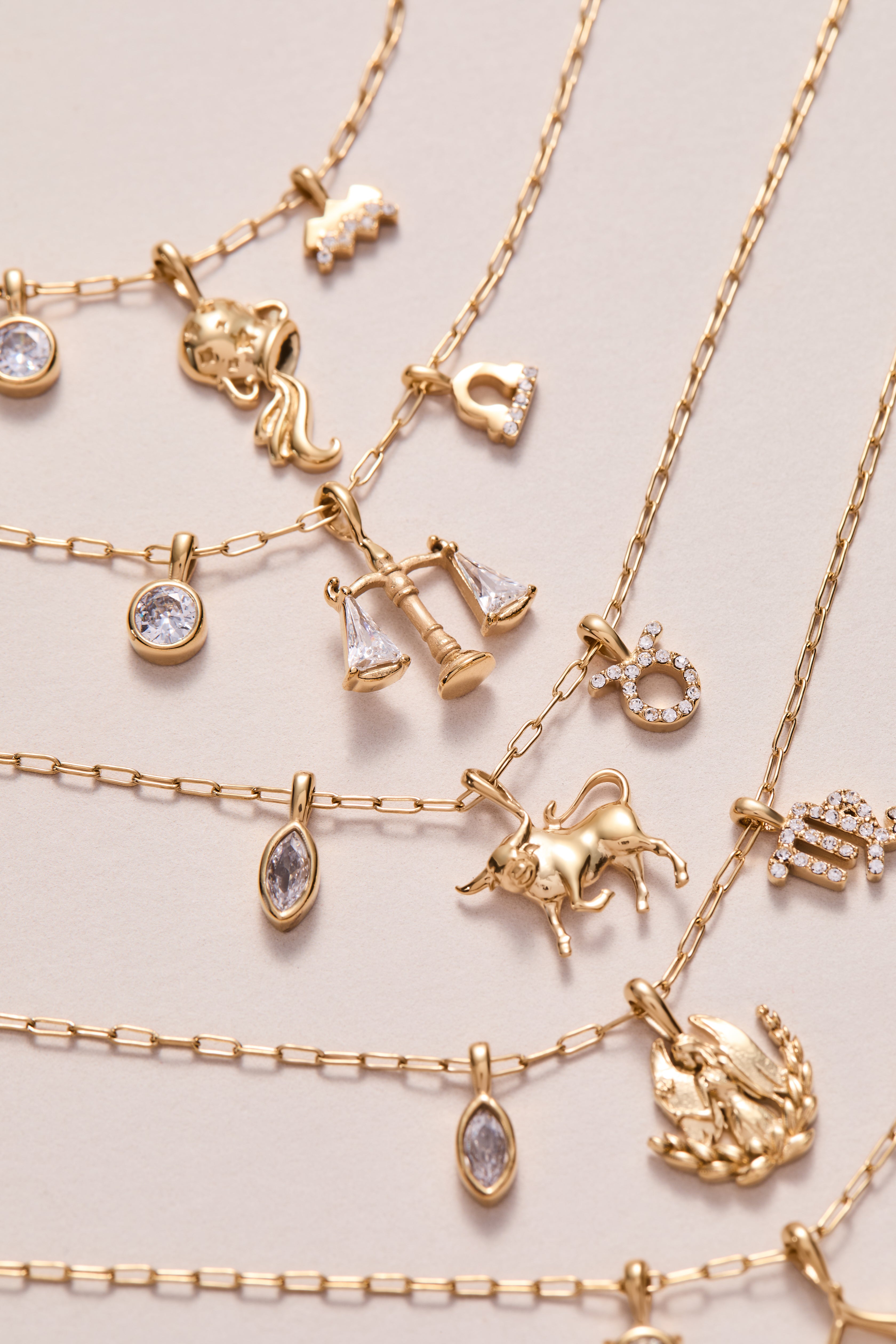 Gold Aquarius Zodiac Charm Cluster Necklace by ALEX AND ANI featuring stainless steel chain and celestial zodiac charms.
