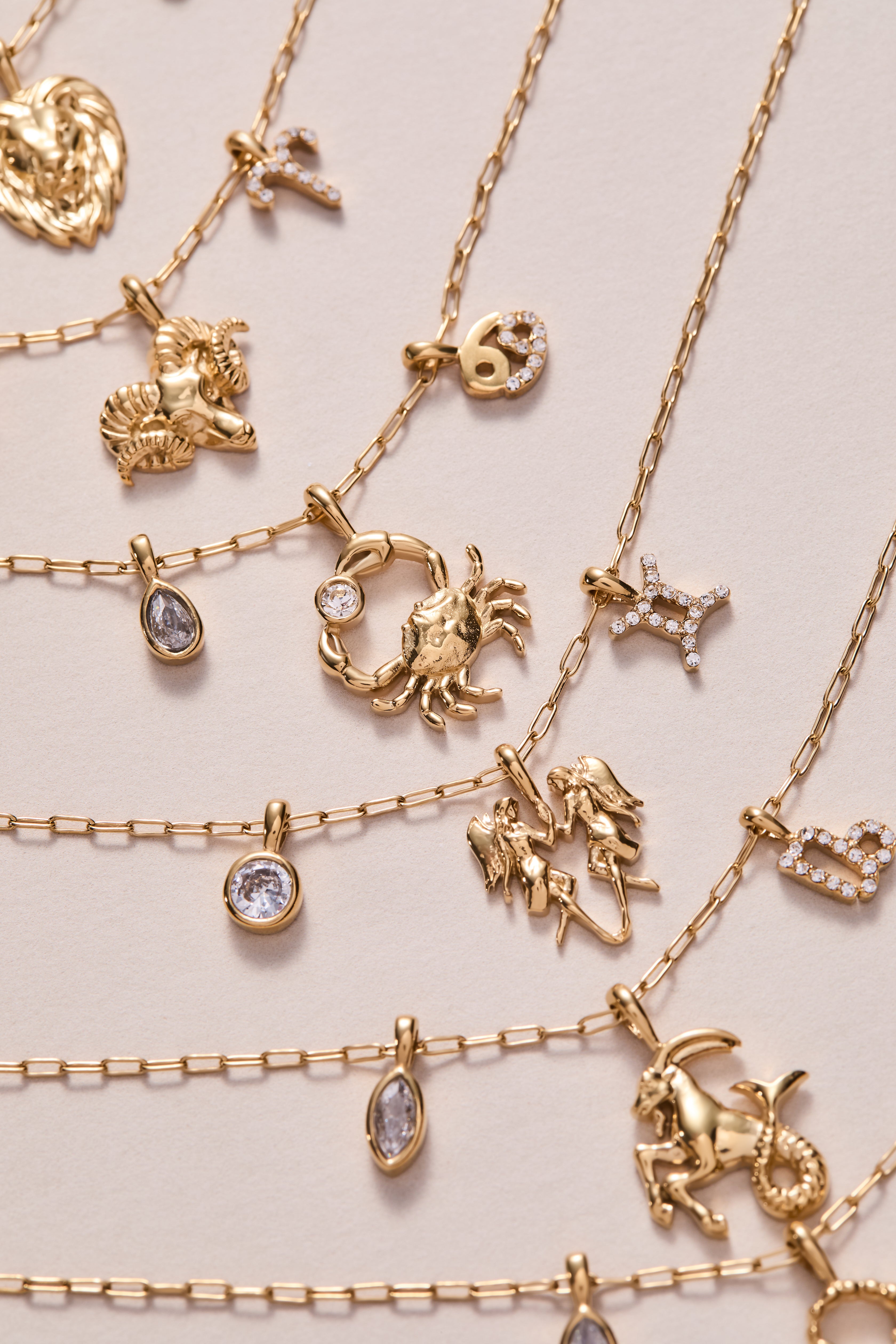 Gold stainless steel Capricorn Zodiac charm cluster necklace by ALEX AND ANI, featuring a detailed Capricorn pendant.