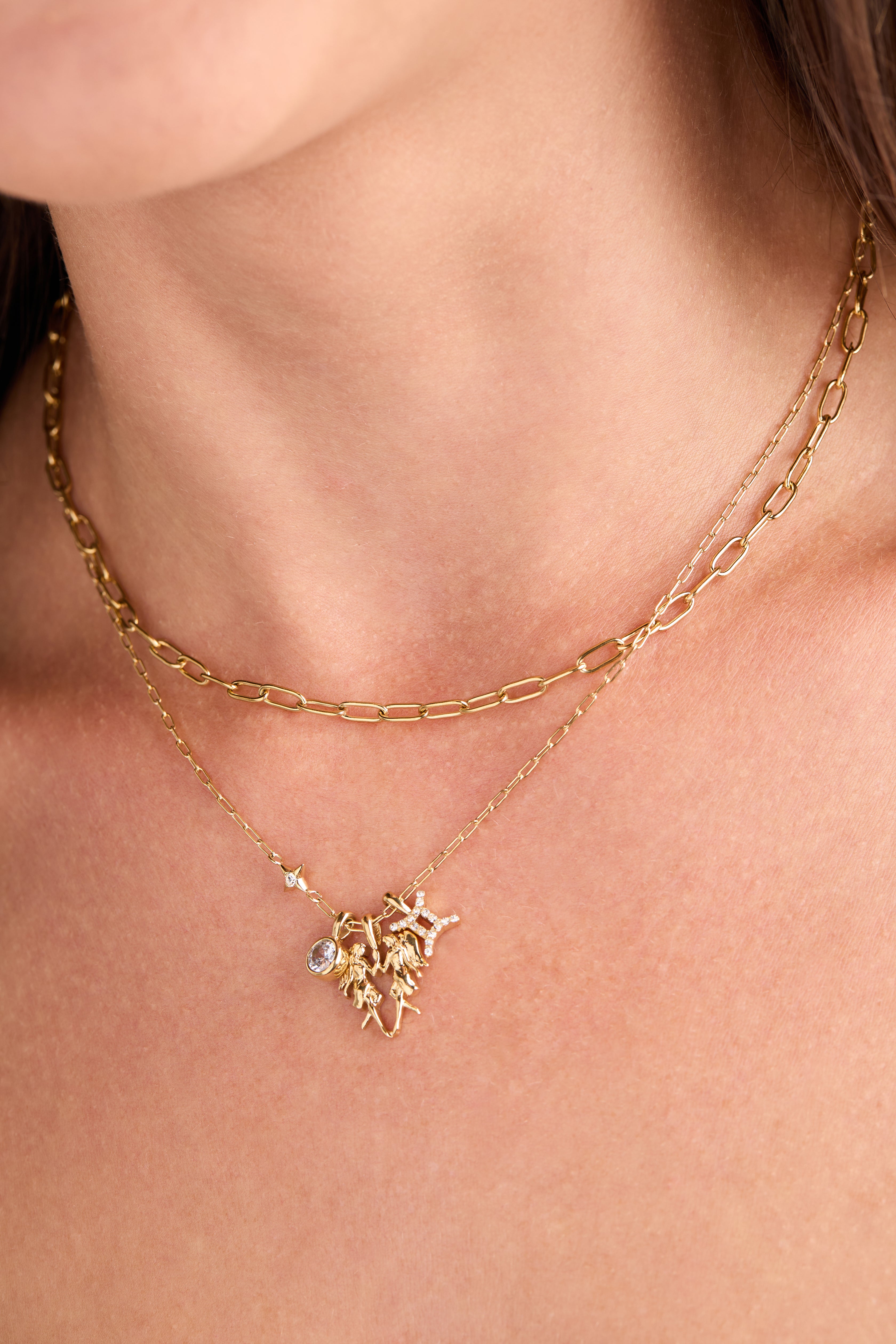 Gold stainless steel Gemini Zodiac Charm Cluster Necklace by ALEX AND ANI with multiple zodiac charms on a delicate chain.