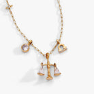 Gold Libra Zodiac Charm Cluster Necklace by ALEX AND ANI featuring stainless steel chain and zodiac pendant.