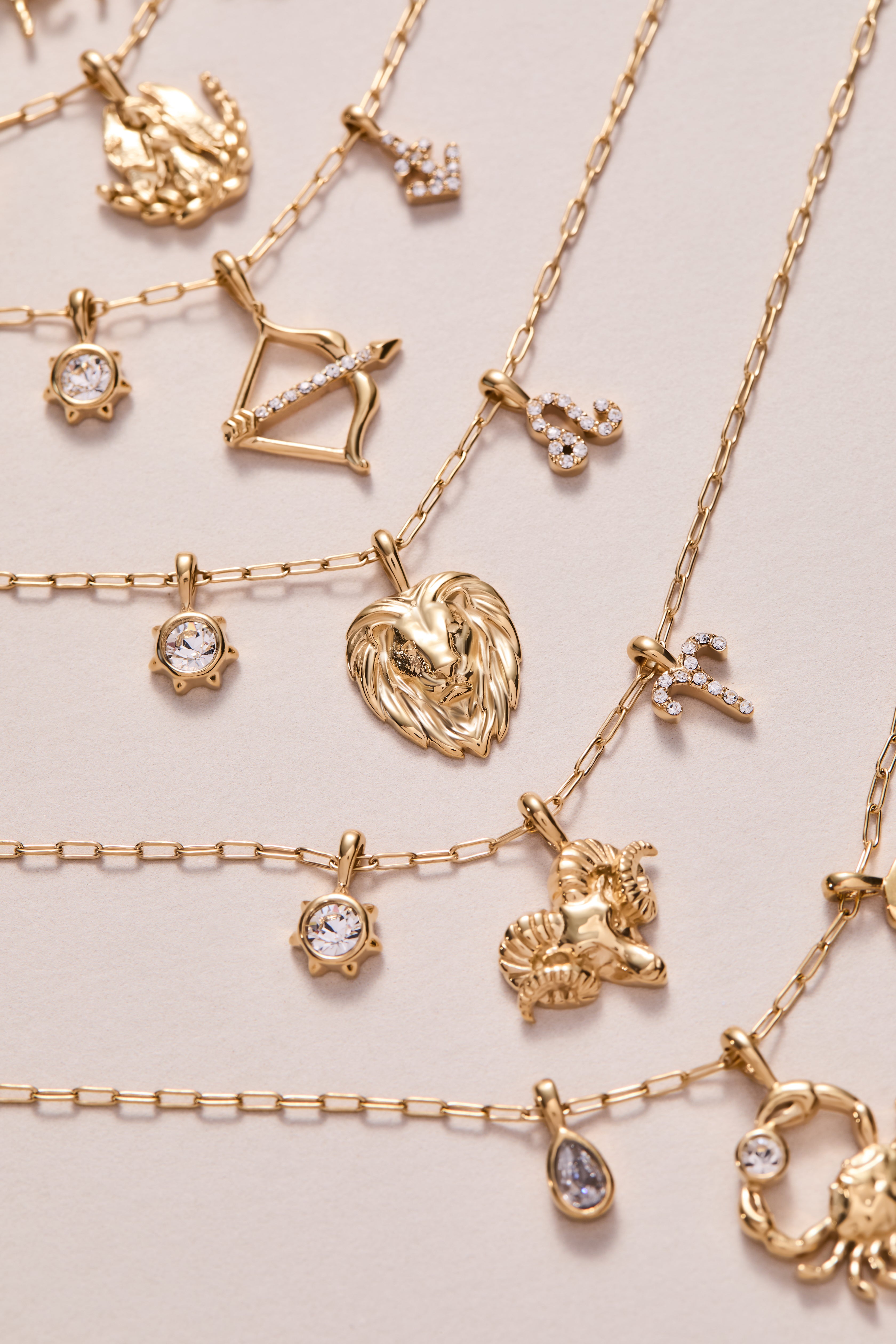 Gold stainless steel Sagittarius zodiac charm cluster necklace by ALEX AND ANI, featuring a celestial-inspired pendant and chain.