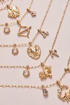 Gold stainless steel Sagittarius zodiac charm cluster necklace by ALEX AND ANI, featuring a celestial-inspired pendant and chain.