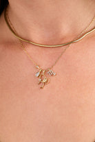 Gold stainless steel Scorpio zodiac charm cluster necklace by ALEX AND ANI, featuring a detailed Scorpio pendant and layered chain design.