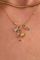 Gold stainless steel Scorpio Zodiac Charm Cluster Necklace from ALEX AND ANI, featuring a detailed Scorpio pendant on a chain.