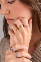 Set of three gold stainless steel Evil Eye stacking rings by Alex and Ani, featuring detailed eye designs and smooth band finishes.