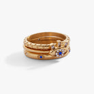 Set of three ALEX AND ANI stainless steel gold evil eye stacking rings, featuring decorative eye designs for stylish jewelry.
