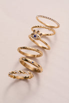 Set of three gold stainless steel Evil Eye stacking rings by ALEX AND ANI, featuring protective eye motifs and sleek design.