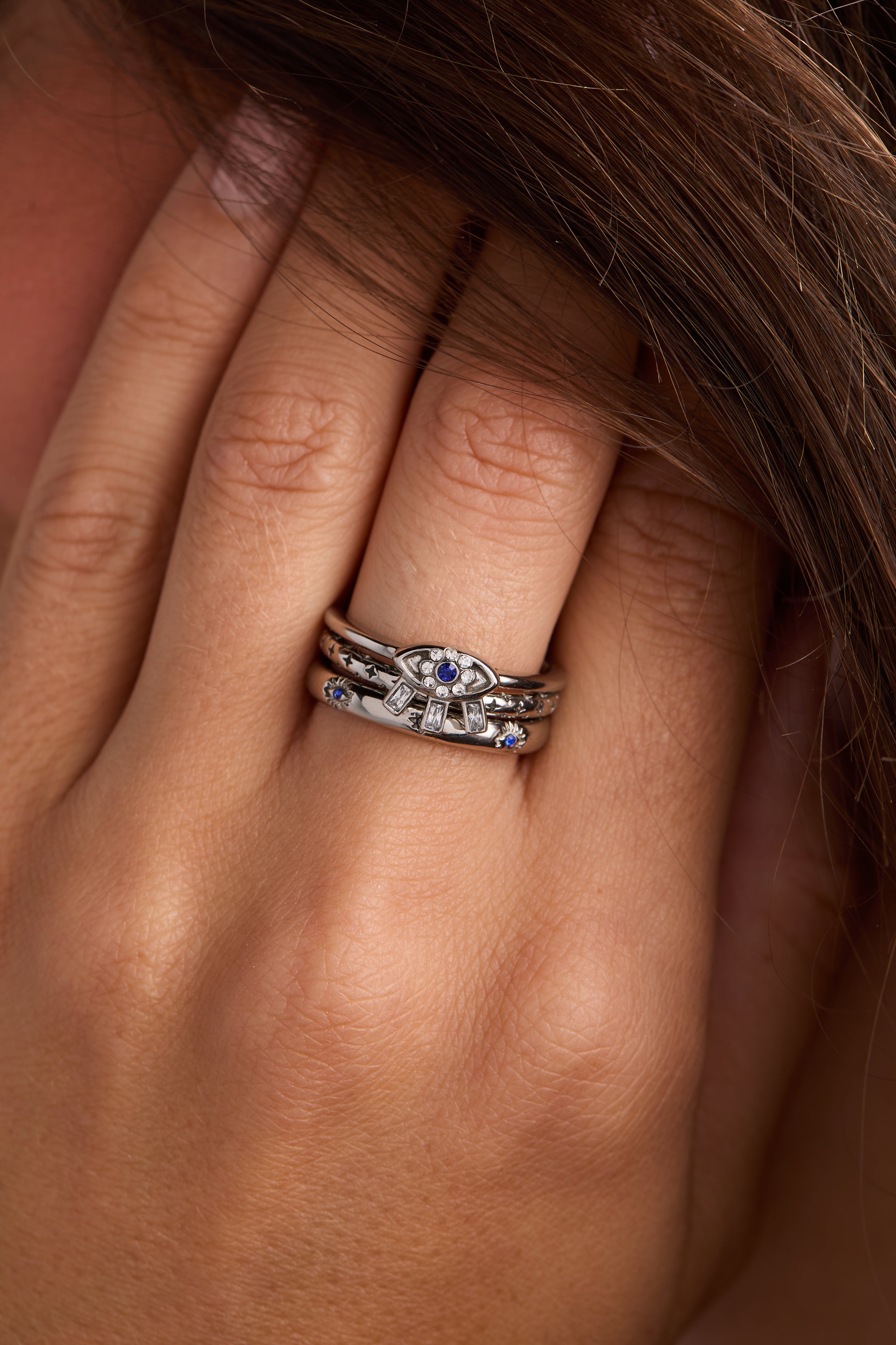 Set of three gold stainless steel Evil Eye stacking rings by ALEX AND ANI, featuring intricate eye designs and smooth bands.