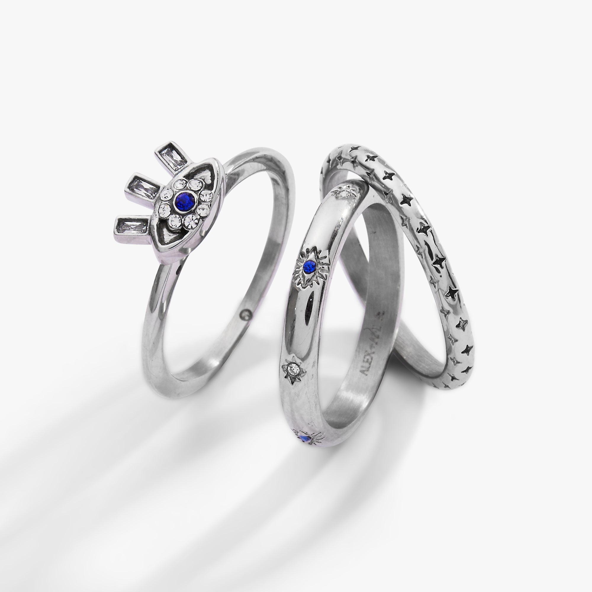 Set of three gold stainless steel Evil Eye stacking rings by ALEX AND ANI, featuring intricate eye designs and smooth bands.