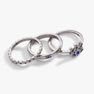 Set of three gold stainless steel Evil Eye stacking rings by ALEX AND ANI, featuring eye motifs and layered design.