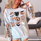 Black Halloween collage graphic tee from Anchored Grace Boutique featuring festive spooky illustrations and bold design.
