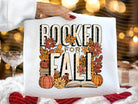 White graphic tee by Anchored Grace Boutique featuring "Booked for Fall" design on Bella style cotton t-shirt.