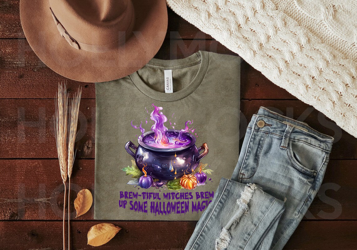 Black graphic tee from Anchored Grace Boutique featuring a Halloween witch brew design with spooky, colorful lettering.