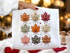 White graphic tee by Anchored Grace Boutique featuring fall leaves design on the front, casual and stylish for autumn.