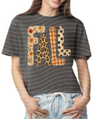 White Fall Patterned Graphic Tee by Anchored Grace Boutique featuring seasonal fall-inspired designs.