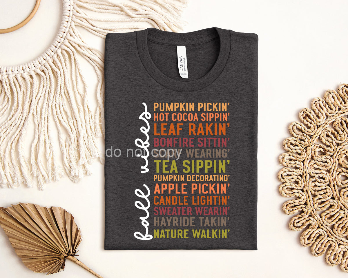 White Fall Vibes graphic tee by Anchored Grace Boutique featuring fall-themed design on soft cotton fabric.