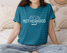 Black graphic tee from Anchored Grace Boutique featuring "Ain't No Hood Like Motherhood" slogan in white text.