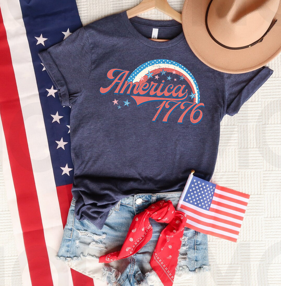 America 1776 graphic tee featuring patriotic design, casual fit, and bold print from Anchored Grace Boutique.