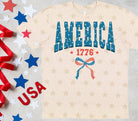 America graphic tee by Anchored Grace Boutique, featuring a stylish design on a casual cotton t-shirt.