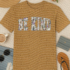 Blue Be Kind graphic tee by Anchored Grace Boutique featuring a positive message and casual fit, displayed on a hanger.